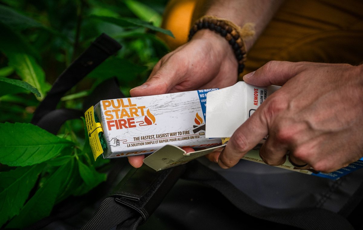 Opening a Pull Start fire starter from the survival bag