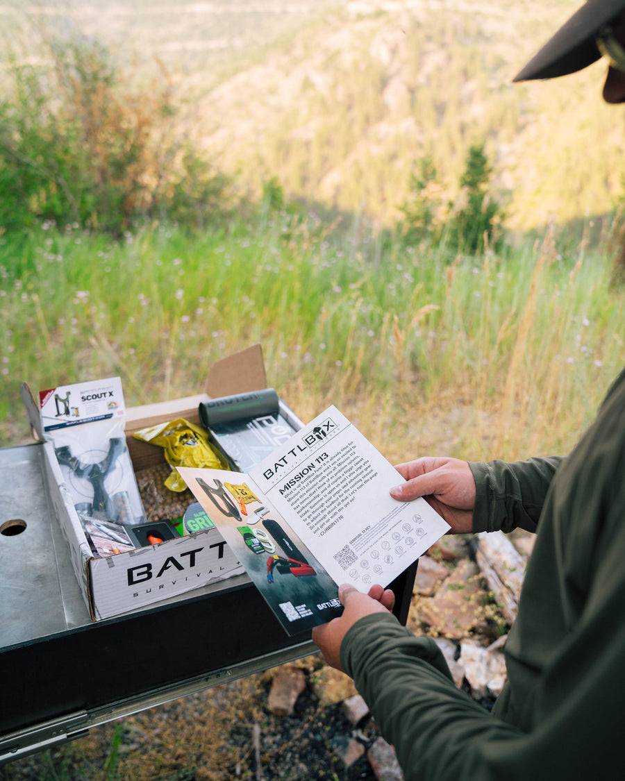 A member reading the mission card next to an open box at camp